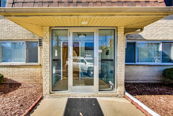Front view of a building entrance with glass doors.