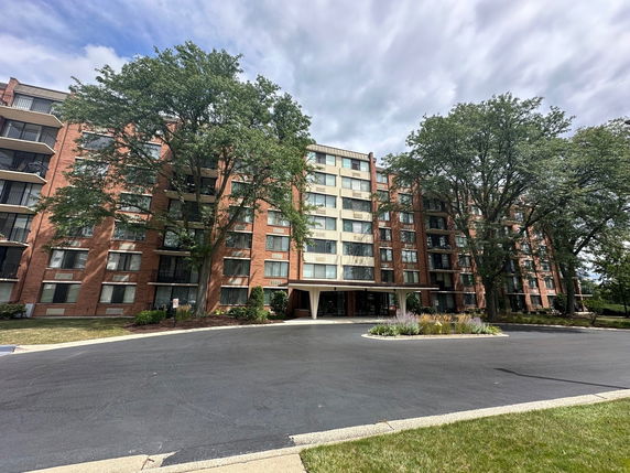 Front view of a multi-story residential building with a brick exterior.