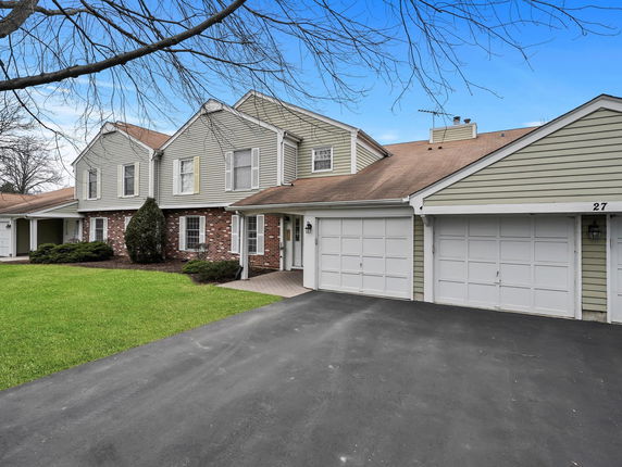 Front view of a two-story house with attached double garage.