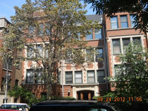 Front view of a multi-story brick apartment building.