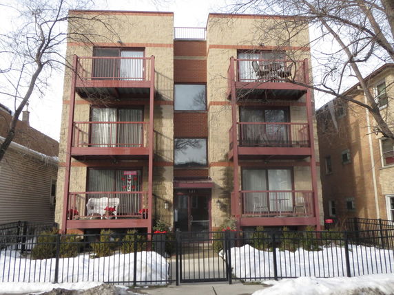 Front view of a multi-story residential building with balconies.