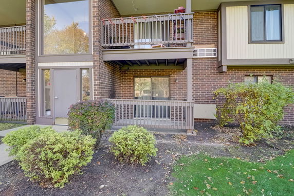 Front view of a two-story brick building with balconies.