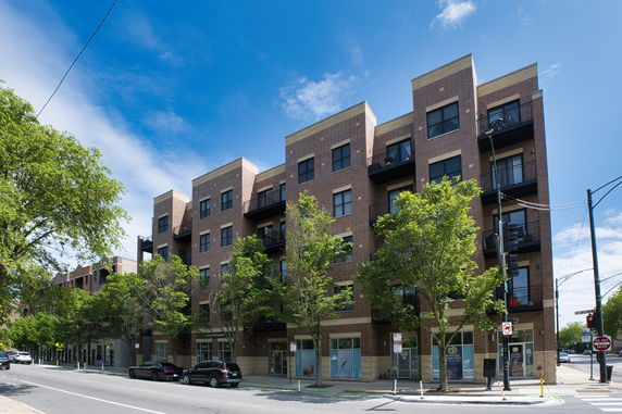 Front view of a four-story brick apartment building.