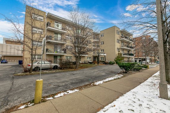Front view of a four-story apartment building.