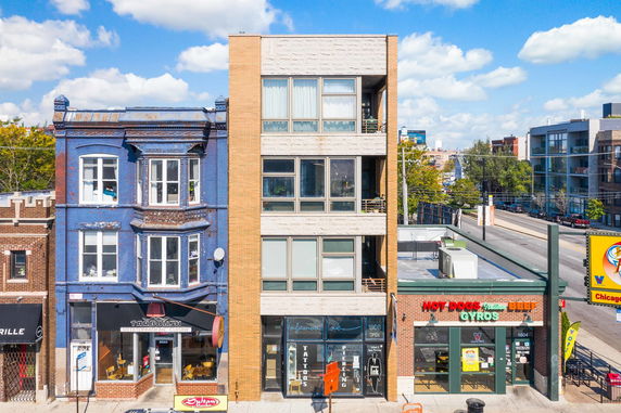 Front view of a building with commercial establishments at the ground level.