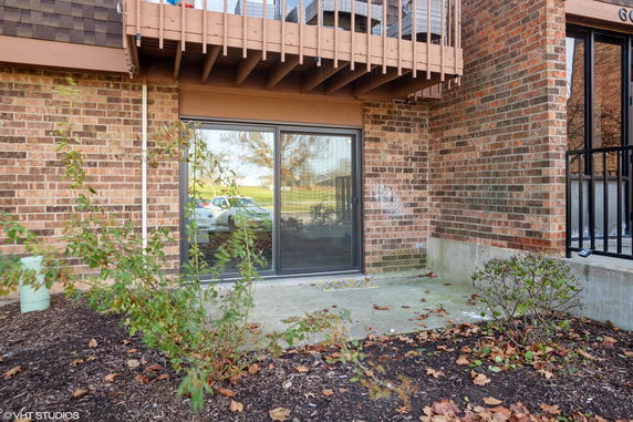 Front view of a brick building with a sliding glass door.
