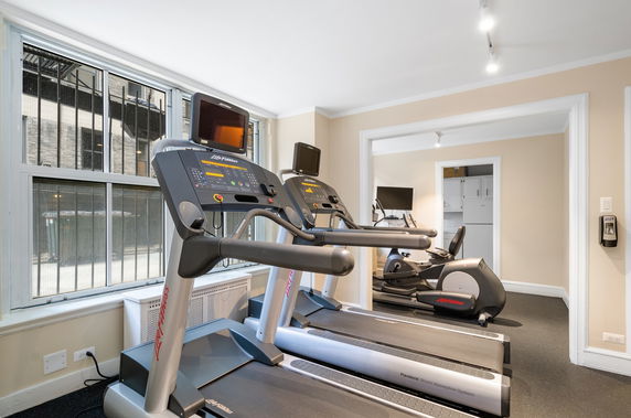 Indoor gym area with treadmills and exercise equipment.