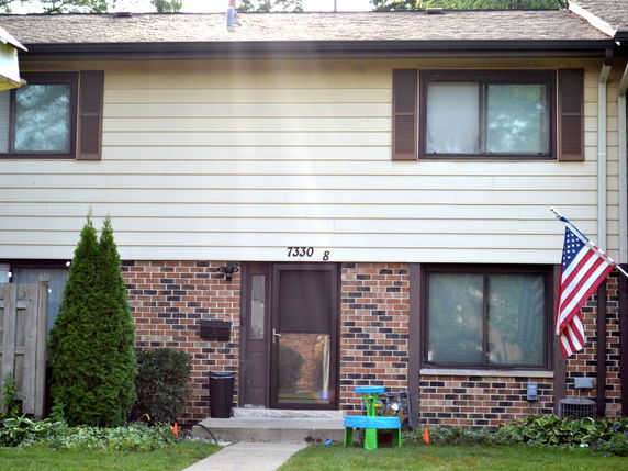 Front view of a two-story house with brick and siding exterior.