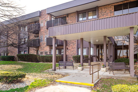 Front view of a multi-story residential building with balconies.