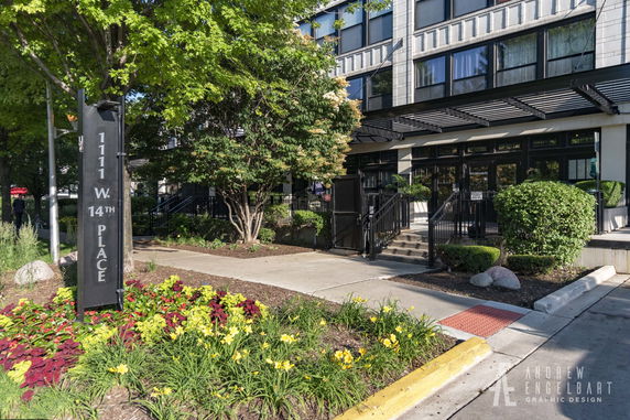 Front view of a building entrance with a pathway and landscaping.
