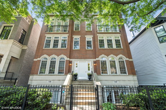 Front view of a three-story brick building with multiple windows and a central entrance.