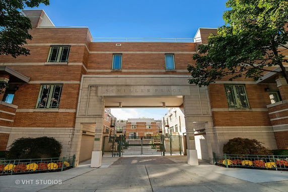 Front view of an urban residential building with a large entrance archway.