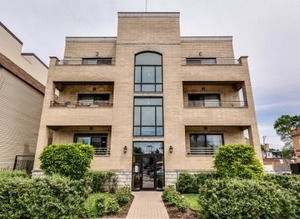 Front view of a multi-story building with balconies.