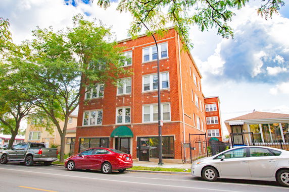 Front view of a four-story brick building.