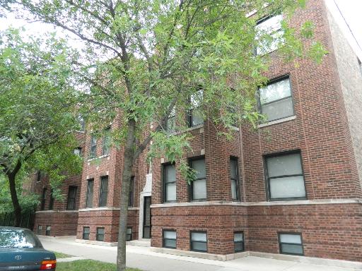 Front view of a multi-story brick apartment building.