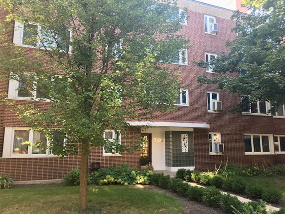 Front view of a multi-story brick apartment building