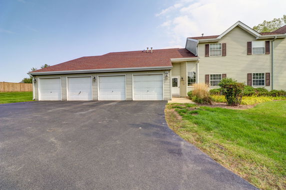 Front view of a two-story house with a three-car garage.