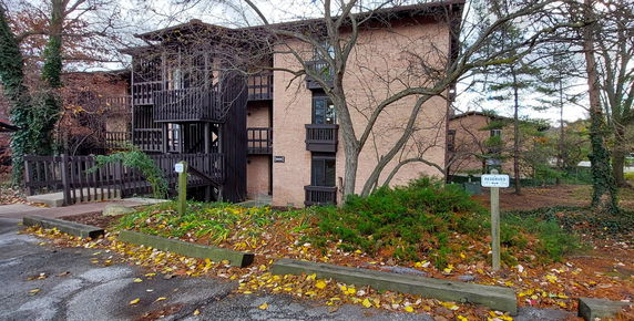 Front view of a multi-story brick building with external wooden staircases.