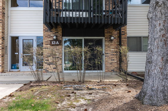 Front view of a residential building with a balcony and entrance labeled 13A.