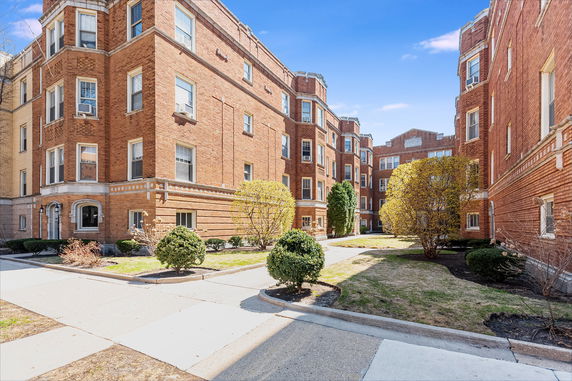 Front view of a multi-story brick apartment building.