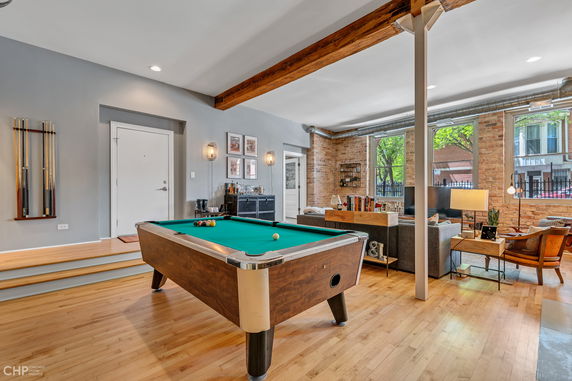 Interior view with a billiard table and seating area.