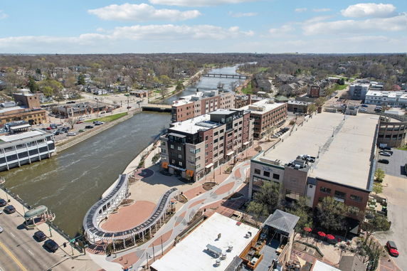 Panoramic view of a riverside urban area with multiple buildings and bridges.