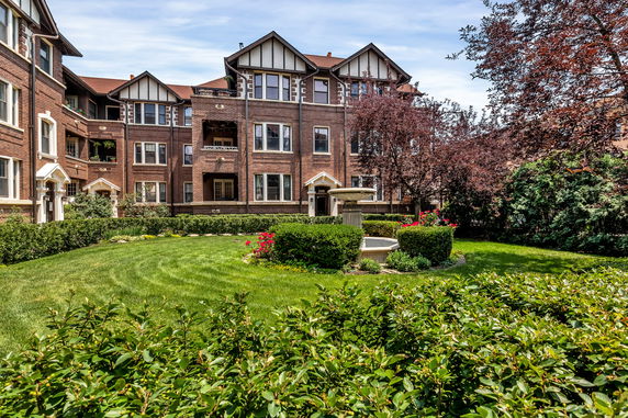 Front view of a multi-story brick building with decorative gables.