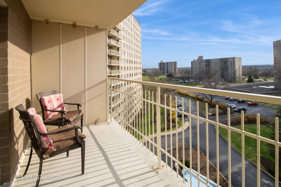 View from a balcony overlooking a residential area with tall apartment buildings.