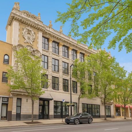 Front view of a historic multi-story building with ornate architectural details.