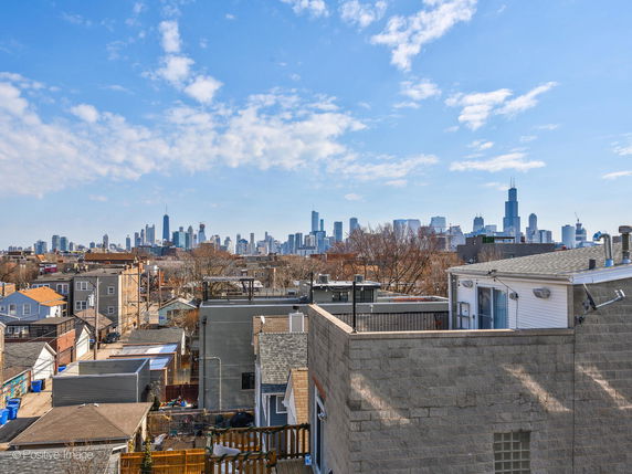 Panoramic view of city skyline from a rooftop.