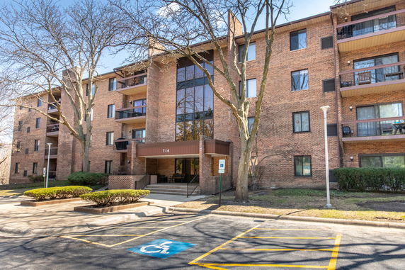 Front view of a multi-story apartment building with balconies.