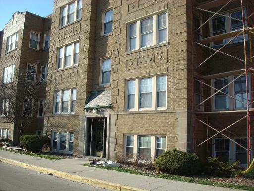 Front view of a multi-story brick apartment building.