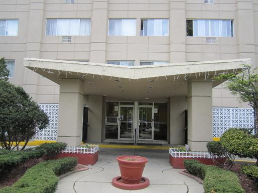 Front view of a multi-story building with a prominent entrance canopy.