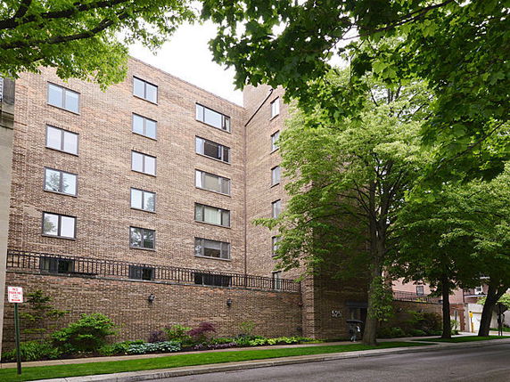 Front view of a multi-story brick apartment building.