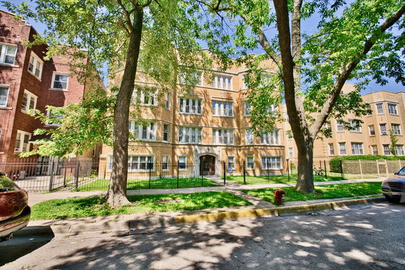 Front view of a multi-story residential building with a brick facade.