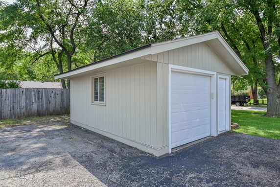 Front view of a small garage with a white garage door.