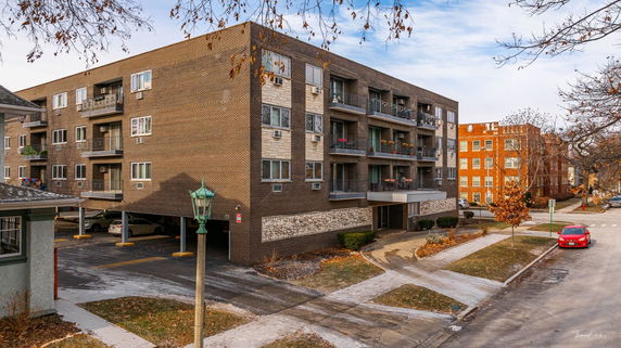 Front view of a multi-story apartment building with balconies.