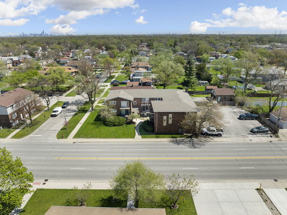 Panoramic view of a residential neighborhood with multiple houses and roads.
