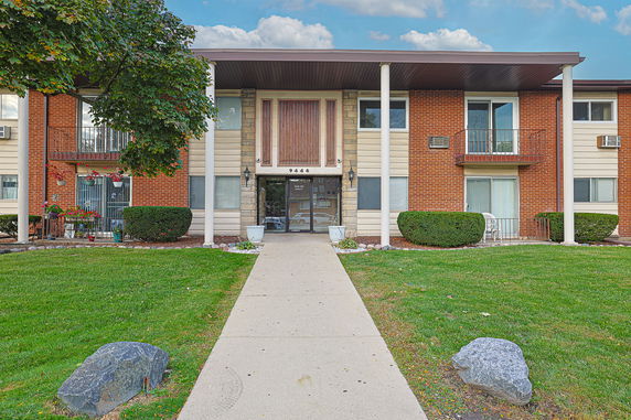 Front view of a multi-story residential building with balconies.