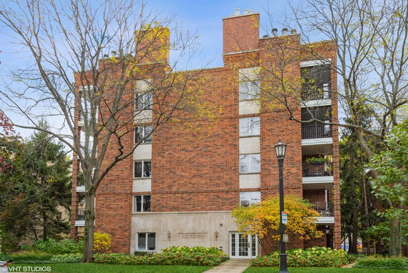 Front view of a multi-story brick building with balconies.