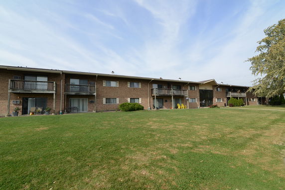 Front view of a multi-unit apartment building with balconies.