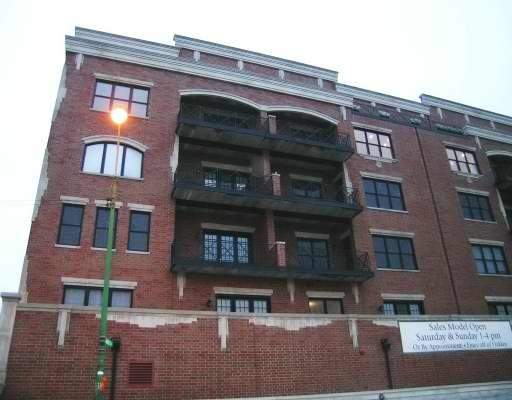 Front view of a multi-story brick building with balconies.