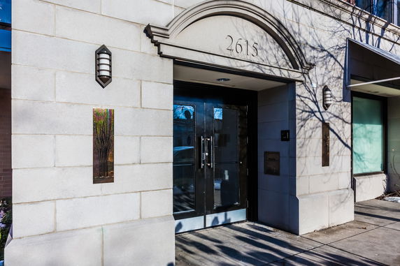 Front view of a building entrance with an arch above the door.