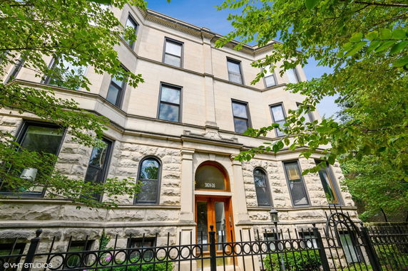 Front view of a multi-story building with a detailed facade and large windows.