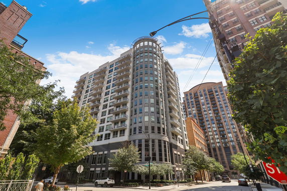 Front view of a multi-story residential building with balconies.