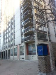 Front view of a multi-story building with balconies.