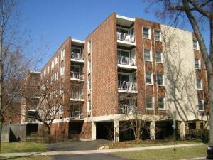 Front view of a multi-story brick apartment building.