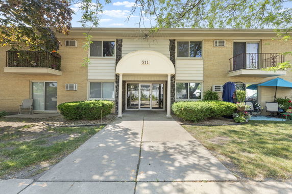 Front view of a two-story apartment building with balconies.