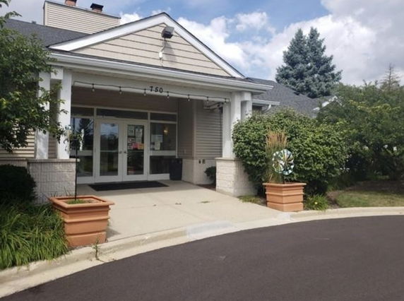 Front view of a building with a gabled roof and entrance area.
