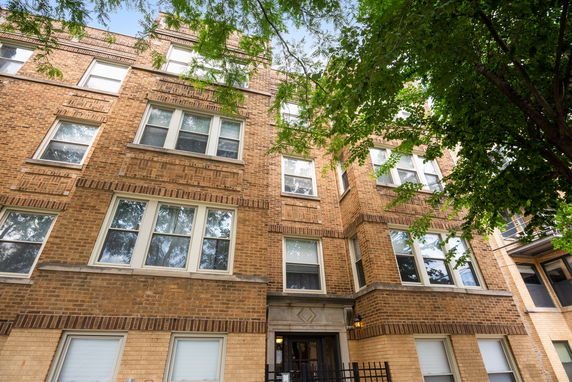 Front view of a multi-story brick apartment building.